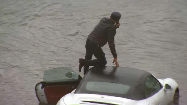 【现场】洪水围困 男子加州高速路跪车顶求助