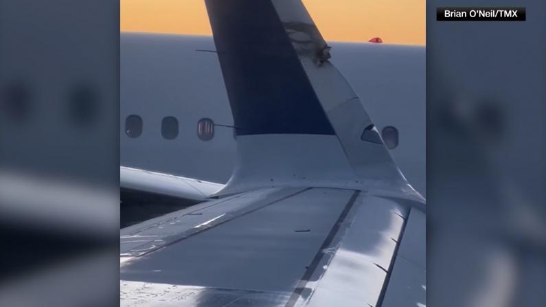 【现场】波士顿机场2飞机碰擦 撞落一小块机翼